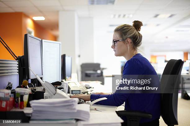 young woman using computer in office - desktop pc stock pictures, royalty-free photos & images