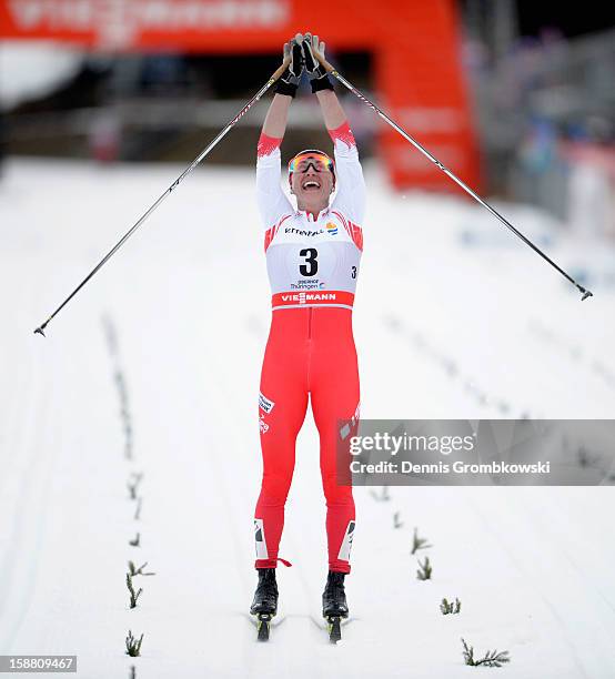 Justyna Kowalczyk of Poland celebrates after winning the Women's 9km Classic Pursuit at the FIS Cross Country World Cup event at DKB Ski Arena on...