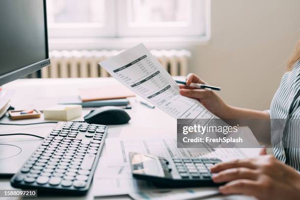 unrecognizable female accountant analyzing the company's financial records - check financial item stock pictures, royalty-free photos & images