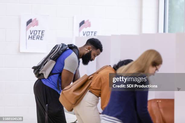 diverse people think about their decisions when voting - bi partisan stock pictures, royalty-free photos & images