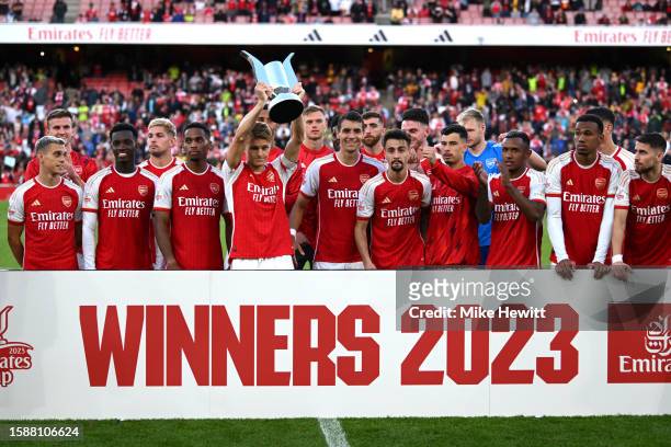 Martin Odegaard of Arsenal lifts the Emirates Cup trophy after the team's victory in the pre-season friendly match between Arsenal FC and AS Monaco...