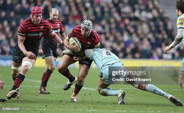 Will Fraser of Saracens is tackled by Courtney Lawes during the Aviva Premiership match between Saracens and Northampton Saints at stadiumMK on...