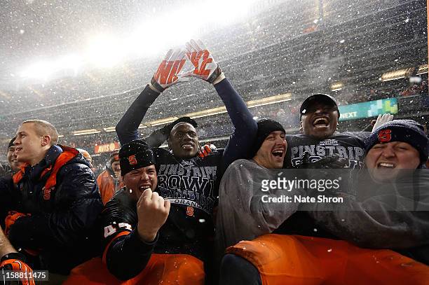 Players of the Syracuse Orange celebrate with fans after the win over the West Virginia Mountaineers during the New Era Pinstripe Bowl at Yankee...