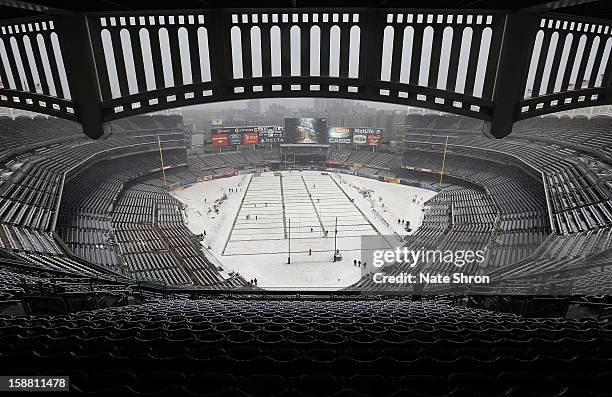 General view of the Yankee Stadium field as snow falls before the New Era Pinstripe Bowl game between the Syracuse Orange and the West Virginia...