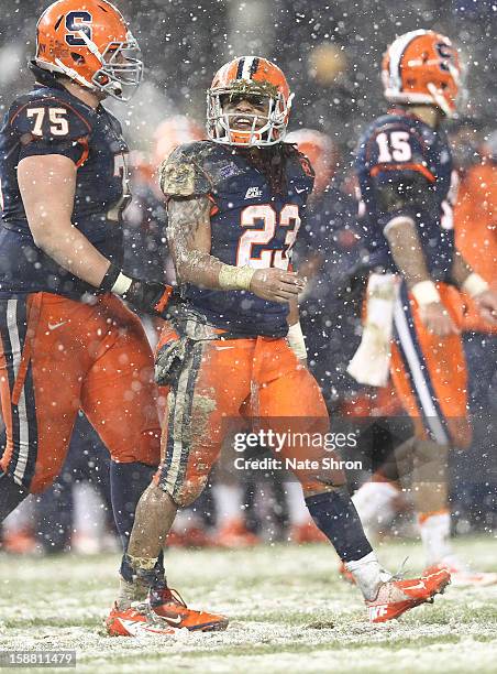 Prince-Tyson Gulley of the Syracuse Orange walks on the field with teamates Zack Chibane and Alec Lemon during the game against the West Virginia...