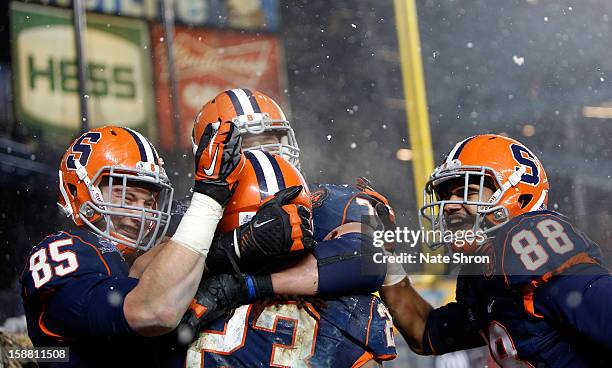 Beckett Wales, Prince-Tyson Gulley, Jarrod West and Zack Chibane of the Syracuse Orange celebrate after a touchdown against the West Virginia...