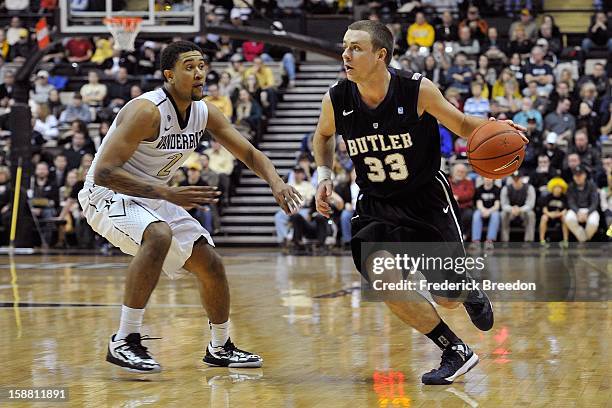 Chase Stigall of the Butler Bulldogs plays against Kedren Johnson of the Vanderbilt Commodores at Memorial Gym on December 29, 2012 in Nashville,...