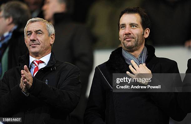 Ian Rush of Liverpol and actor Clive Owen watch from the stands during the Barclays Premier League match between Queens Park Rangers and Liverpool at...