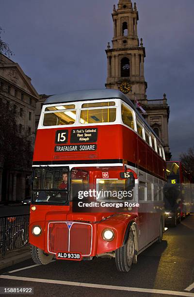An older style double deck bus moves along The Strand near Covent Garden on December 7 in London, England. Central London captures the Christmas...