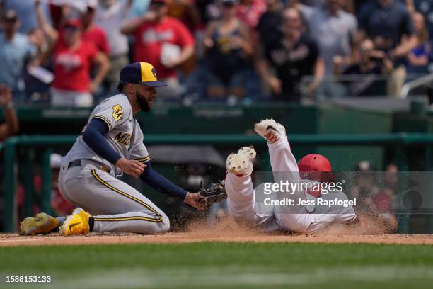 Devin Williams of the Milwaukee Brewers can't make the tag in time as Ildemaro Vargas of the Washington Nationals scores the game-winning run at...