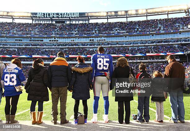Martellus Bennett of the New York Giants stands with families of Sandy Hook Elementary School before the game against the Philadelphia Eagles their...