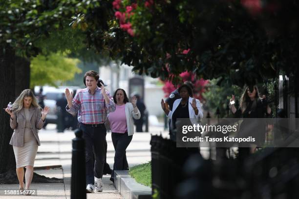 People evacuate the Dirksen Senate Office Building following a report of an active shooter at the Russell Senate Office Building on Capitol Hill on...