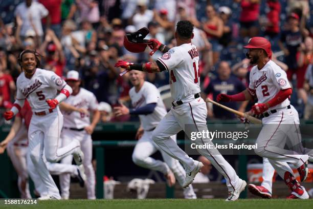 Ildemaro Vargas of the Washington Nationals celebrates with teammates after scoring the game-winning run against the Milwaukee Brewers at Nationals...