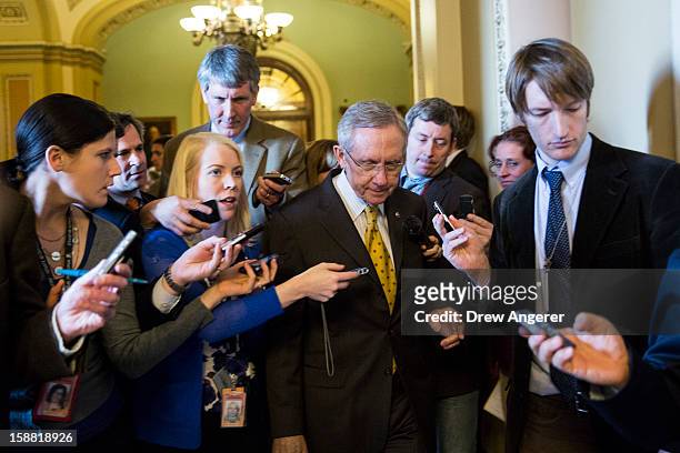 Senate Majority Leader Harry Reid leaves the Senate Chamber and heads to a meeting with Senate Democrats on Capitol Hill December 30, 2012 in...