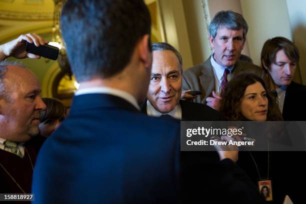 Senator Chuck Schumer talks with reporters on his way to a meeting with Senate Democrats on Capitol Hill December 30, 2012 in Washington, DC. The...