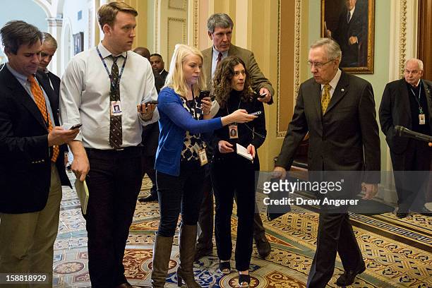 Senate Majority Leader Harry Reid leaves the Senate Chamber, on Capitol Hill, on December 30, 2012 in Washington, DC. The House and Senate are both...