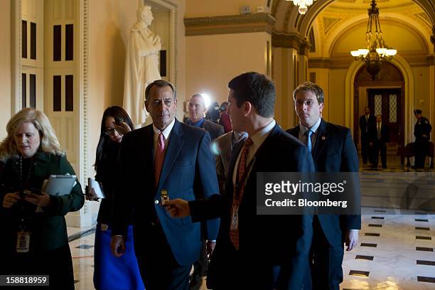 House Speaker John Boehner, a Republican from Ohio, center left, is surrounded by members of the media as he walks through the U.S. Capitol in...