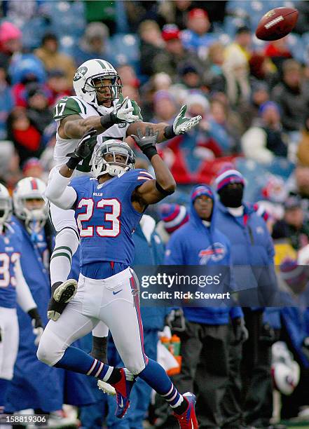 Braylon Edwards of the New York Jets goes up for a pass against Aaron Williams of the Buffalo Bills at Ralph Wilson Stadium on December 30, 2012 in...