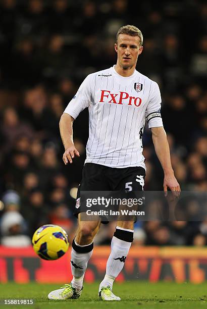 Brede Hangeland of Fulham controls the ball during the Barclays Premier League match between Fulham and Swansea City at Craven Cottage on December...