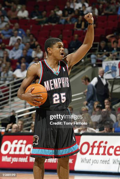 Earl Watson of the Memphis Grizzlies with his arm raised calls the formation on the court during the NBA preseason game against the Orlando Magic at...