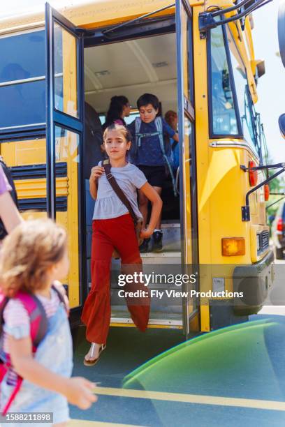 kids getting off school bus at - gå i land bildbanksfoton och bilder