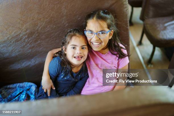sisters riding school bus together - sister stock pictures, royalty-free photos & images