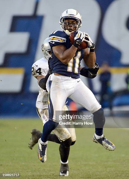 Eddie Royal of the San Diego Chargers makes a catch for a first down in front of Michael Huff of the Oakland Raiders during a 24-21 win at Qualcomm...
