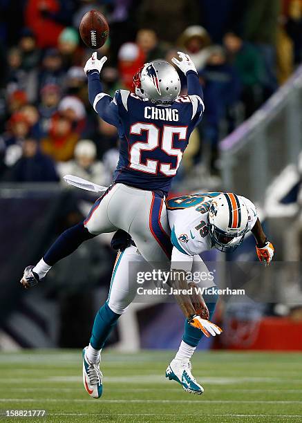 Patrick Chung of the New England Patriots breaks up a pass in front of Armon Binns of the Miami Dolphins in the second half during the game at...