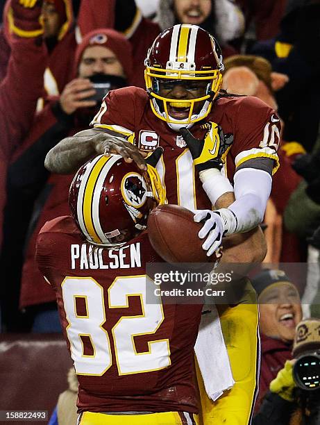 Robert Griffin III celebrates his third quarter touchdown against the Dallas Cowboys with Logan Paulsen of the Washington Redskins at FedExField on...