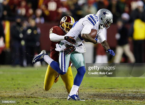 Madieu Williams of the Washington Redskins tackles Kevin Ogletree of the Dallas Cowboys after Ogletree caught a fourth quarter pass at FedExField on...