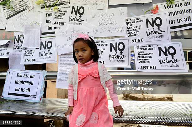 Child at a makeshift memorial to mourn the death of a 23-year-old gang rape victim near a bus stop at Munirka in New Delhi on Saturday. The girl was...
