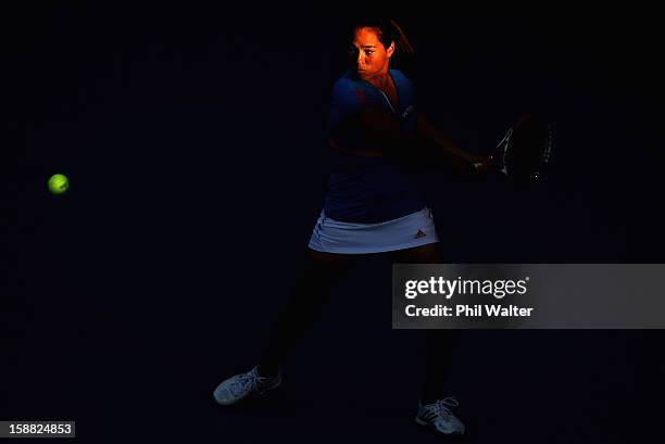 Jamie Hampton of the USA plays a backhand in her first round match against Jie Zheng of China during day one of the 2013 ASB Classic on December 31,...