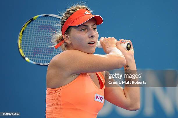 Ksenia Pervak of Kazakhstan plays a forehand in her match against Caroline Wozniacki of Denmark during day two of the Brisbane International at Pat...