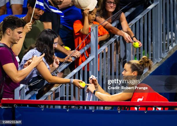 Maria Sakkari of Greece signs autographs after losing to Danielle Collins of the United States in the second round on Day 3 of the National Bank Open...