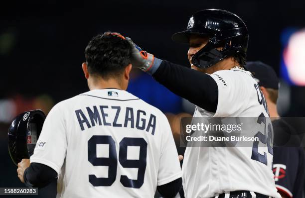 Miguel Cabrera of the Detroit Tigers rubs the head of first base coach Alfredo Amezaga after his 3,145th hit in the seventh inning of a game against...