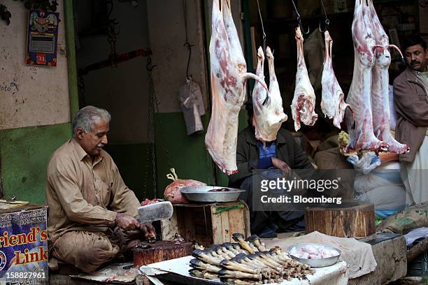 Goat carcasses hang at a butcher's stall at a market in Rawalpindi, Pakistan, on Sunday, Dec. 30, 2012. Pakistan’s economy will probably expand 3.5...