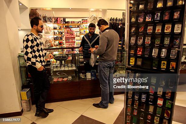 An employee helps a customer at Shams supermarket in Islamabad, Pakistan, on Sunday, Dec. 30, 2012. Pakistan’s economy will probably expand 3.5...