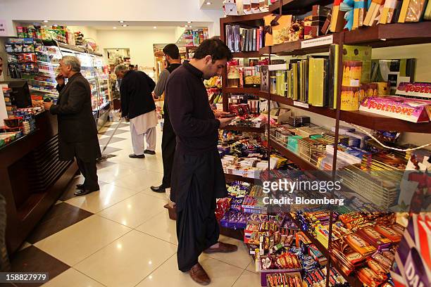 People shop at Shams supermarket in Islamabad, Pakistan, on Sunday, Dec. 30, 2012. Pakistan’s economy will probably expand 3.5 percent in the 12...