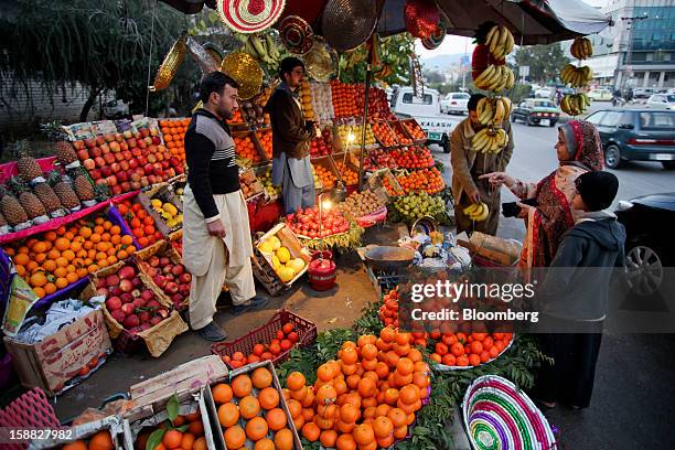 Vendors sell fruits by a road in Islamabad, Pakistan, on Sunday, Dec. 30, 2012. Pakistan’s economy will probably expand 3.5 percent in the 12 months...