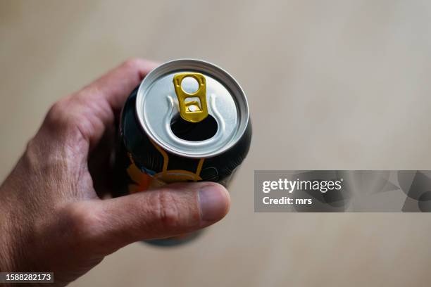 hand holding open soda drink can - man holding soda can stock pictures, royalty-free photos & images