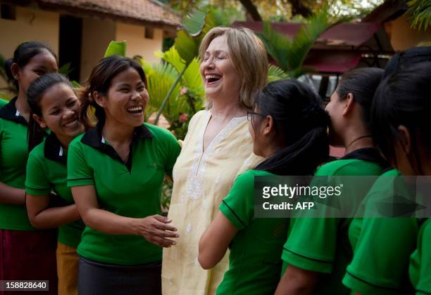 Secretary of State Hillary Rodham Clinton greets children during a tour of the Siem Reap Center, a shelter run by AFSEIP that provides...