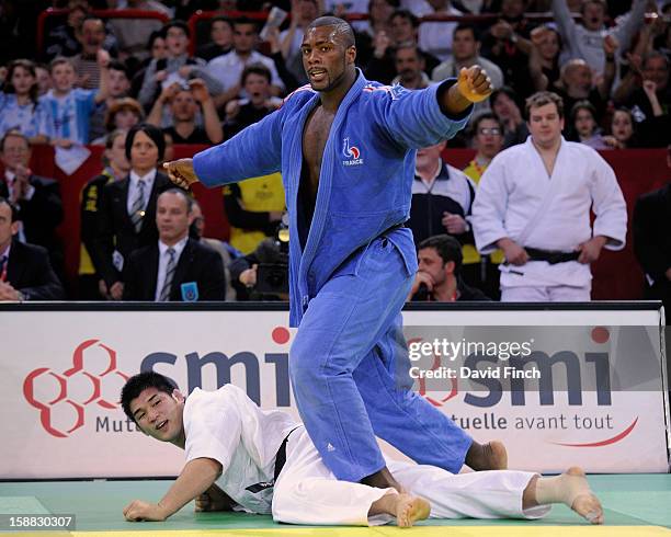 French World champion, Teddy Riner , celebrates defeating Sydney Olympic gold medallist, Kosei Inoue of Japan, with a counter attack in extra time to...