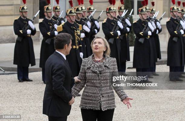 France's president Nicolas Sarkozy speaks to US Secretary of State Hillary Clinton as she arrives on March 19, 2011 at the Elysee Palace in Paris,...