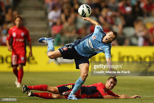 Brett Emerton of Sydney is tackled by Cameron Watson of Adelaide during the round 14 A-League match between Adelaide United and Sydney FC at...