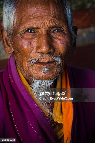 Old man in the monastery in the village Chimi Lhakhang in the Punakha Valley with its temple, monastery is renowned for its fertility blessings,...