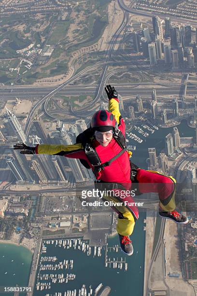 skydiver enjoying the view in free fall over dubai - パラシュート ストックフォトと画像