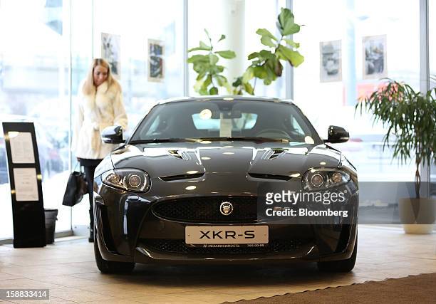 Customer inspects a Jaguar XKR-S series automobile on display at an independent auto showroom in Moscow, Russia, on Friday, Dec. 28, 2012. Tata...