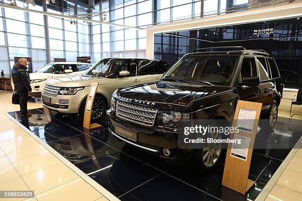 Customer inspects new Range Rover automobiles on display in an independent auto showroom in Moscow, Russia, on Friday, Dec. 28, 2012. Tata Motors...