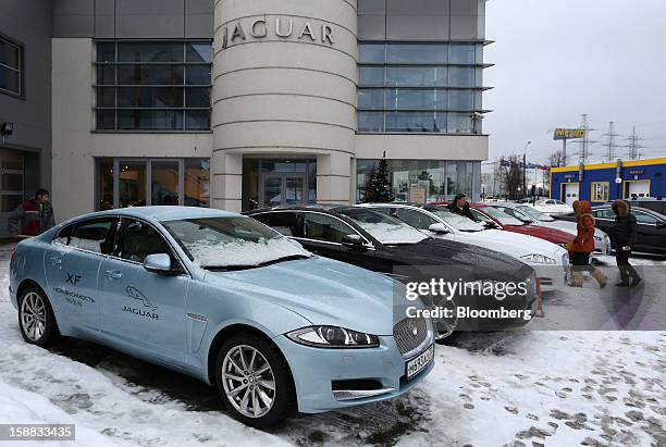 Jaguar XJ series automobiles stand on the forecourt of an independent auto showroom for customers to test in Moscow, Russia, on Friday, Dec. 28,...