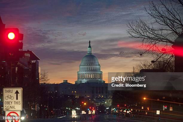 Dawn breaks at the U.S. Capitol in Washington, D.C., U.S., on Monday, Dec. 31, 2012. U.S. Lawmakers hurtled toward a midnight deadline to avert...